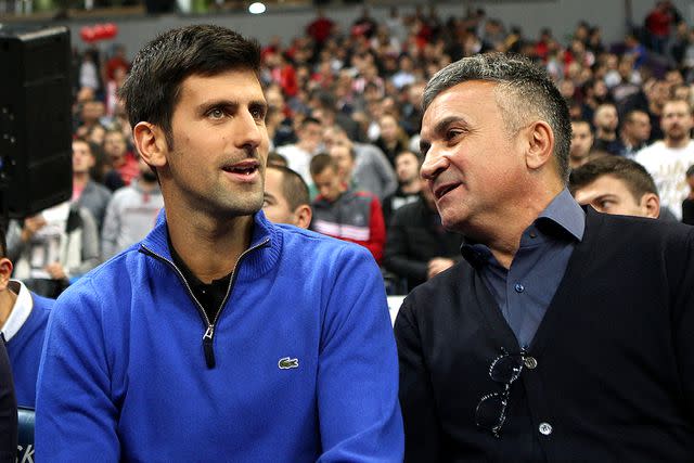 <p>Marko Metlas/Euroleague Basketball via Getty </p> Novak Djokovic seen with his dad, Srdjan, at Kombank Arena in Serbia on Nov. 15, 2017.