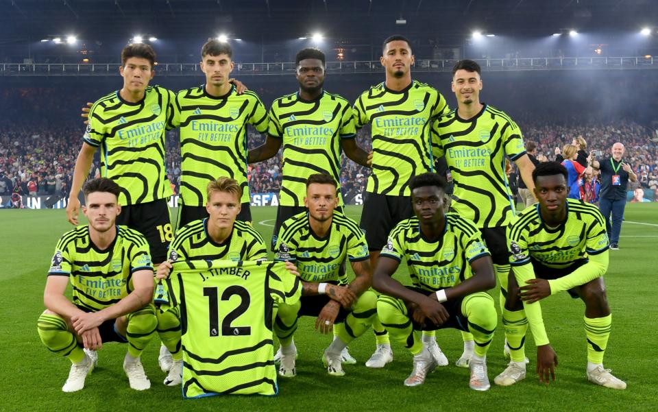 The Arsenal team line up for a photo as Martin Odegaard of Arsenal