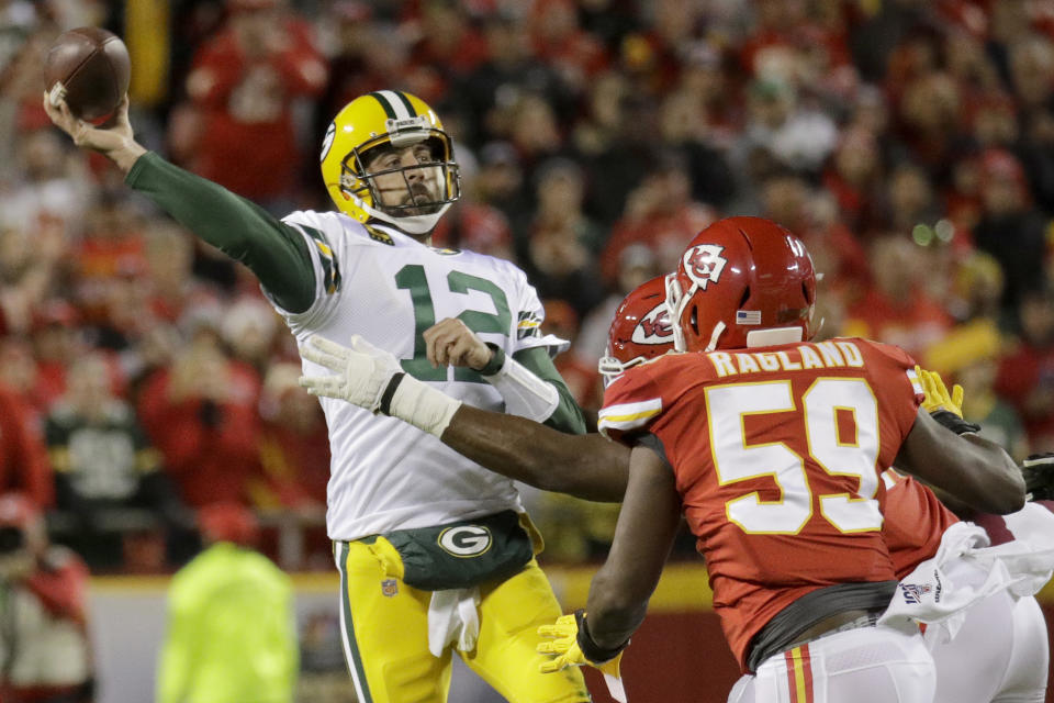 Green Bay Packers quarterback Aaron Rodgers (12) throws a pass under pressure from Kansas City Chiefs linebacker Reggie Ragland (59) during the first half of an NFL football game in Kansas City, Mo., Sunday, Oct. 27, 2019. (AP Photo/Charlie Riedel)