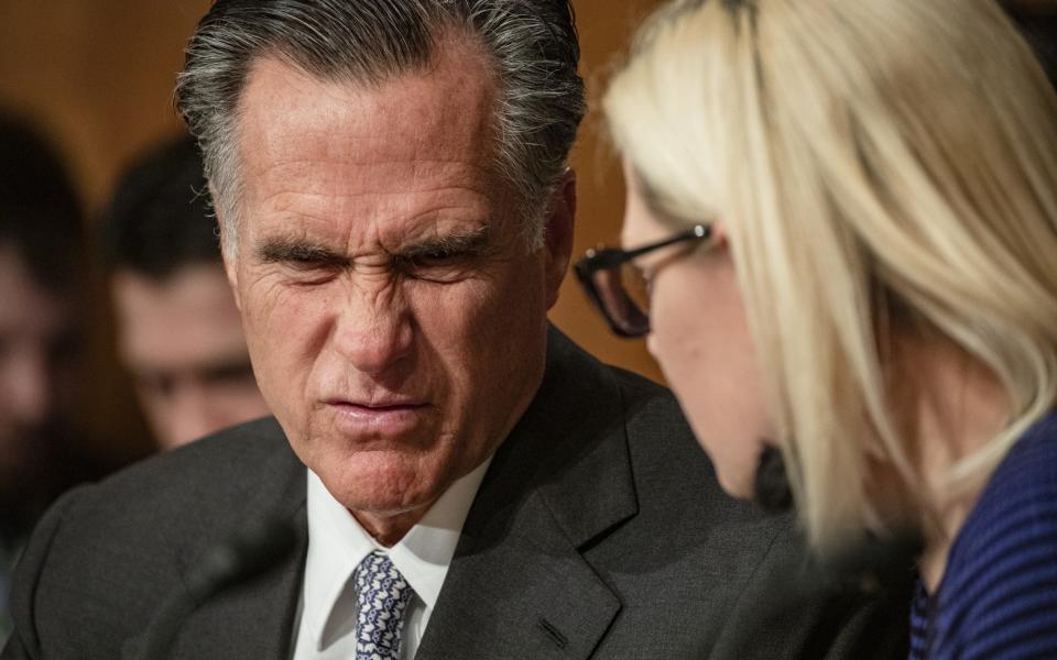 Sen. Mitt Romney and Sen. Kyrsten Sinema speak to each other during a Senate Homeland Security Committee hearing on the government's response to the novel coronavirus (COVID-19) outbreak on March 5, 2020 in Washington, DC - Samuel Corum / Getty