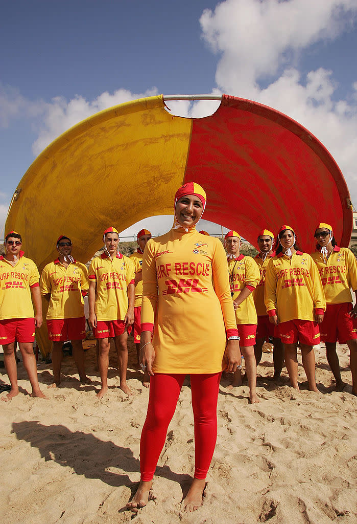 SYDNEY, AUSTRALIA - FEBRUARY 04:  Mecca Laa Laa (C) wears a 'Burqini' on her first surf lifesaving patrol at North Cronulla Beach February 4, 2007 in Sydney, Australia. The red and yellow 'Burqini' was specially designed for Muslim lifesavers to allow females to fulfil both their patrolling and religious obligations.  (Photo by Matt King/Getty Images)