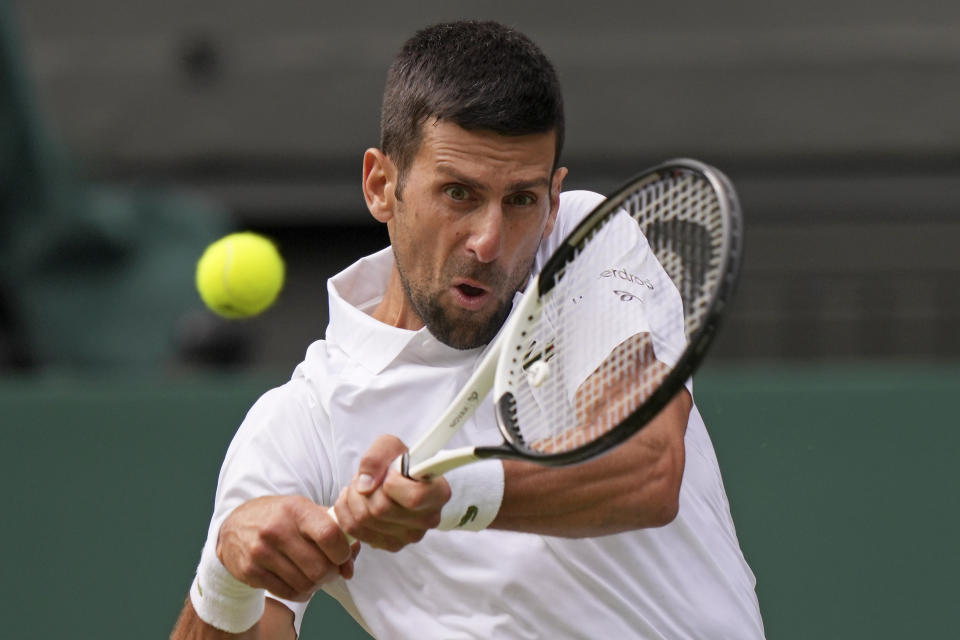 Serbia's Novak Djokovic returns to Poland's Hubert Hurkacz in a men's singles match on day eight of the Wimbledon tennis championships in London, Monday, July 10, 2023. (AP Photo/Alberto Pezzali)