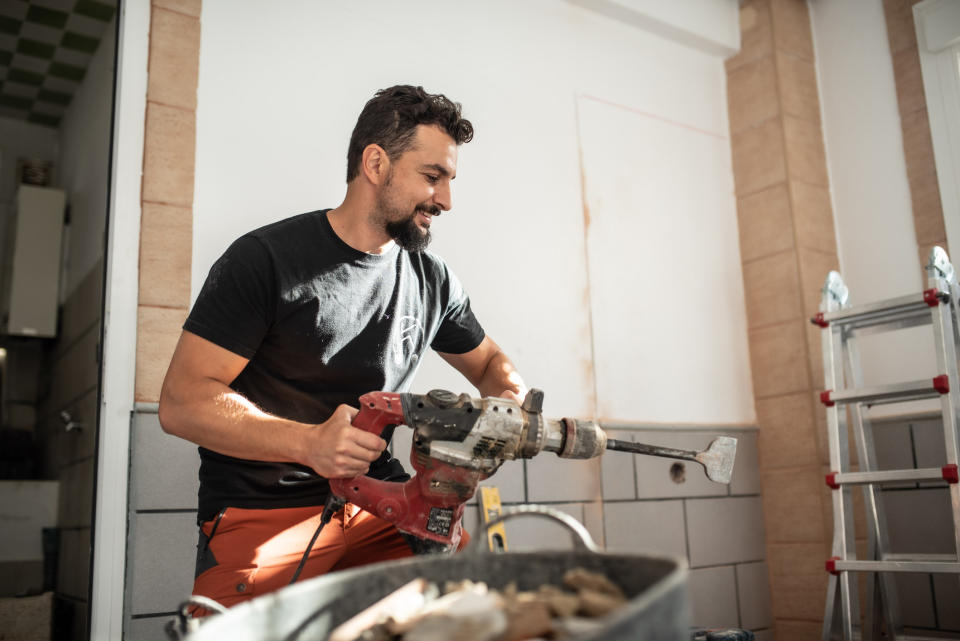 Smiling man handles a jackhammer