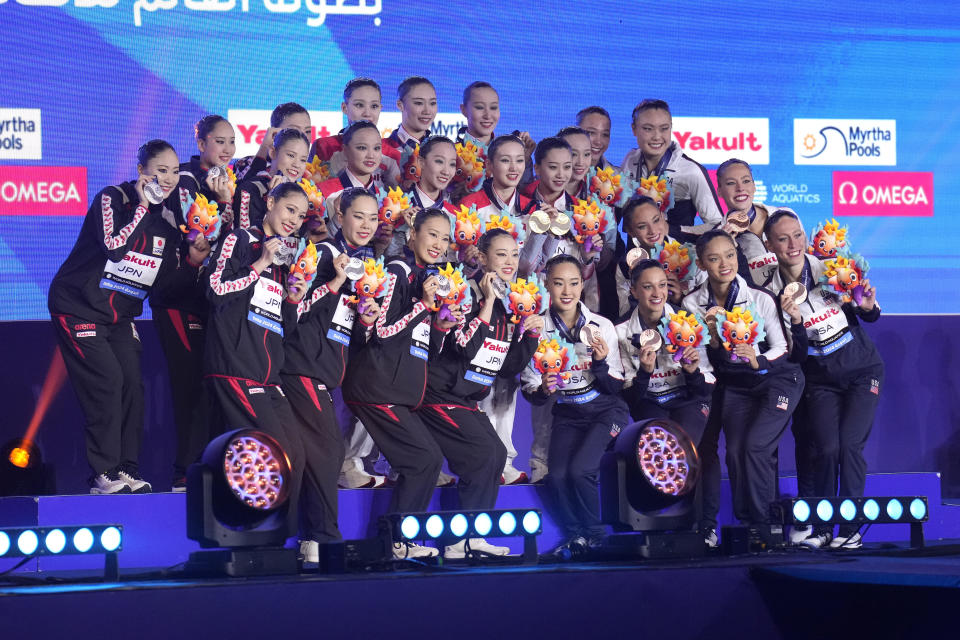 Gold medalists China team, silver medalists Japan team and bronze medalists United States team pose for a photo during the medal ceremony for the mixed team free final of artistic swimming at the World Aquatics Championships in Doha, Qatar, Friday, Feb. 9, 2024. (AP Photo/Lee Jin-man)