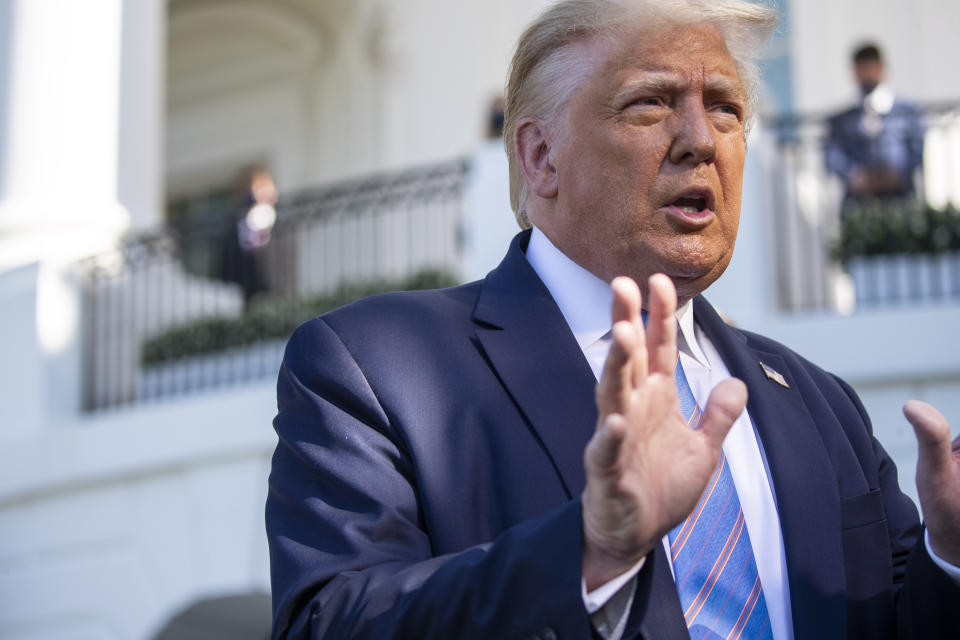 President Donald Trump speaks with reporters as he walks to Marine One on the South Lawn of the White House, Wednesday, July 29, 2020, in Washington. Trump is en route to Texas. (AP Photo/Alex Brandon)