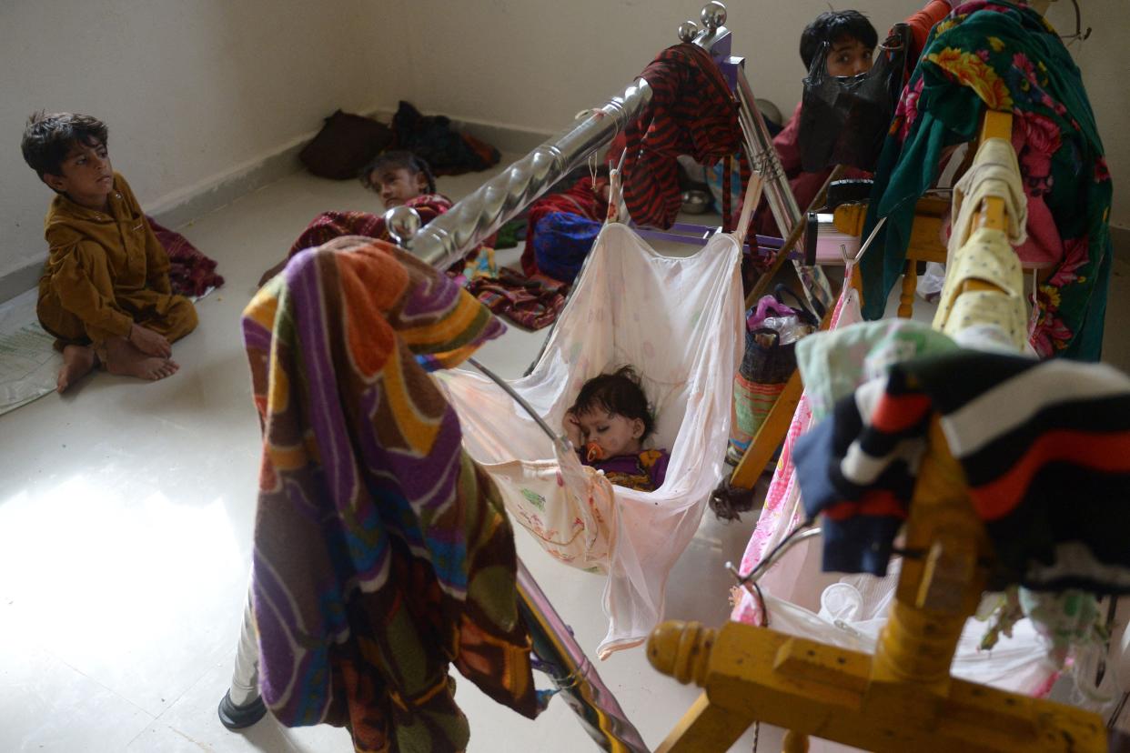 Children rest in a temporary shelter set at a primary health centre in Jakhau village of Kutch district in Gujarat (AFP via Getty Images)