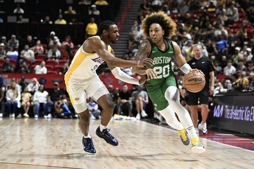 LAS VEGAS, NEVADA - JULY 15: JD Davison #20 of the Boston Celtics drives past Bronny James Jr. #9 of the Los Angeles Lakers in the first half of a NBA Summer League game at the Thomas & Mack Center on July 15, 2024 in Las Vegas, Nevada. NOTE TO USER: User expressly acknowledges and agrees that, by downloading and or using this photograph, User is consenting to the terms and conditions of the Getty Images License Agreement. (Photo by Candice Ward/Getty Images)