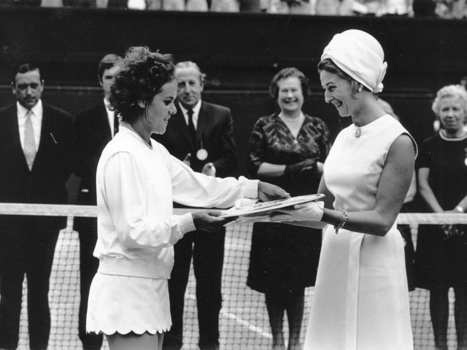 Evonne Goolagong Cawley accepts her Wimbledon trophy from Princess Alexandra.