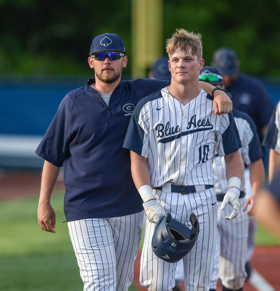 Granville assistant coach Mark Langkamp and Conner Buerkel share a moment following a 12-5 loss to Hartley in a Division II district final May 25 at Beavers Field in Lancaster.