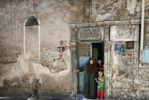 Sabiha Jassem, 61, stands in the doorway of her home in west Mosul