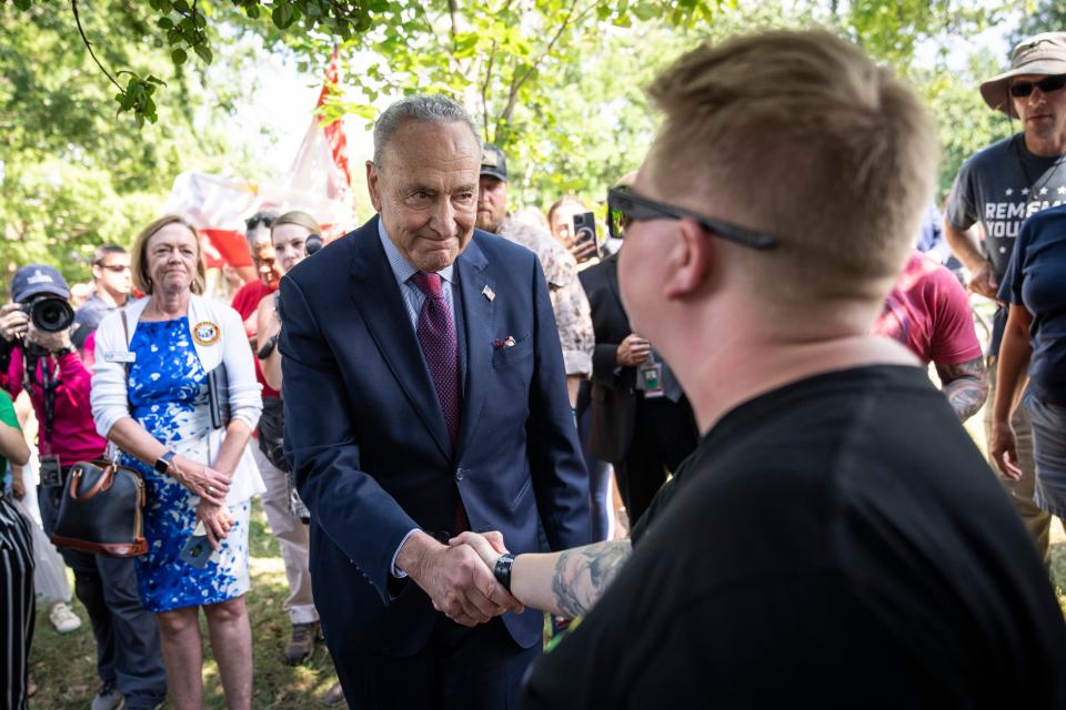 Senate Majority Leader Chuck Schumer, D-N.Y., greets veterans and families before the Senate vote on the PACT Act outside the U.S. Capitol August 2, 2022, in Washington, DC. Demonstrators from veterans-rights groups including the Wounded Warrior Project, Burn Pit 360 and the American Legion, have stood outside the Capitol Building in protest to call on the U.S. Senate to pass the PACT Act, a bill to expand health care benefits for veterans exposed to toxic burn pits.