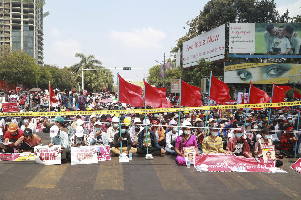 Anti-coup protesters gather in Yangon, Myanmar Saturday, Feb. 20, 2021. Anti-coup protesters in Myanmar's two largest cities on Saturday paid tribute to Mya Thwet Thwet Khine, the young woman who died a day earlier after being shot by police during a rally against the military takeover. (AP Photo)