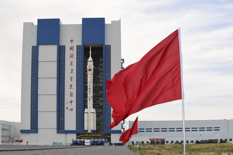 In this photo released by Xinhua News Agency, the Shenzhou-12 manned spaceship with its Long March-2F carrier rocket is being transferred to the launching area of Jiuquan Satellite Launch Center in northwestern China's Gansu province, on Wednesday, June 9, 2021. A three-man crew of astronauts will blast off in June for a three-month mission on China's new space station, according to a space official who was the country's first astronaut in orbit in May. (Wang Jiangbo/Xinhua via AP)