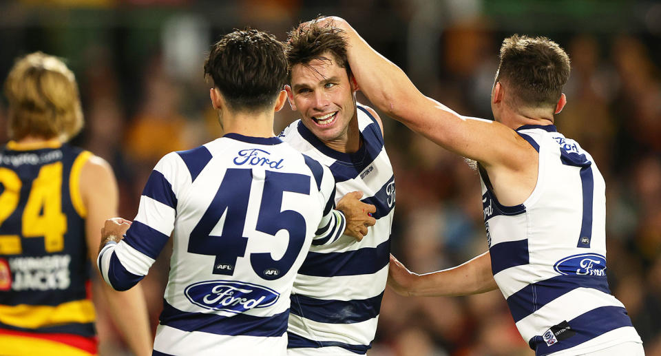 Seen here, Tom Hawkins is congratulated by Geelong teammates.