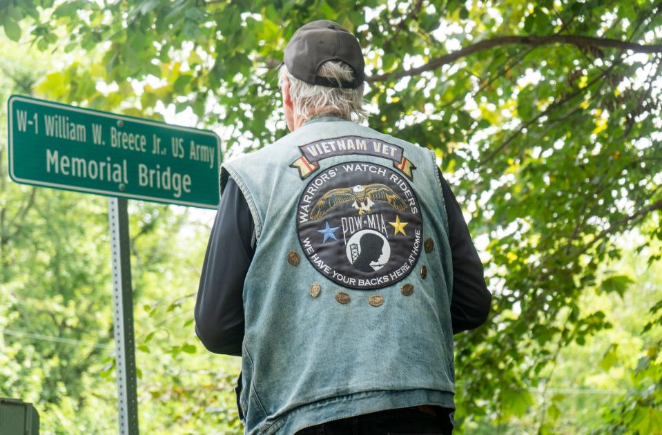 Ken Walker, from Doylestown, looks at the dedication sign after the dedication and renaming ceremony of Bucks County Bridge no.313 in honor of Warrant Officer William Warren Breece Jr., who was killed in action during the Vietnam War in 1968, in Yardley on Wednesday, Aug. 23, 2023.