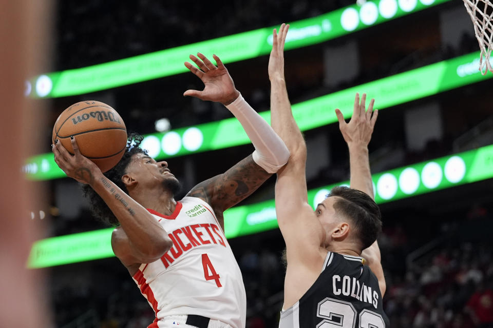 Houston Rockets' Jalen Green (4) shoots as San Antonio Spurs' Zach Collins (23) defends during the first half of an NBA basketball game Tuesday, March 5, 2024, in Houston. (AP Photo/David J. Phillip)