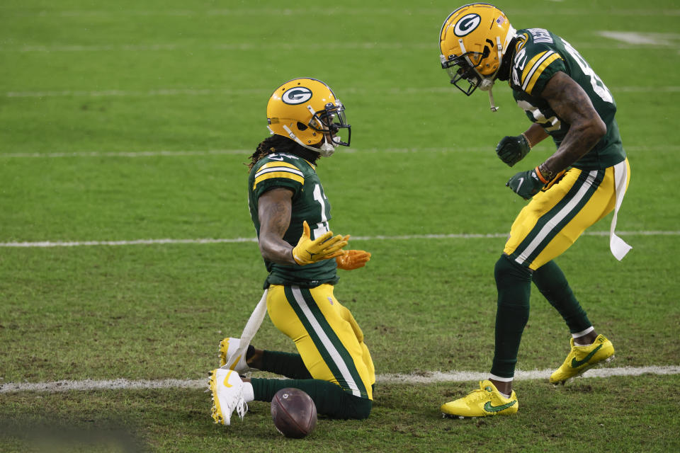 Green Bay Packers' Davante Adams, left, celebrates after scoring with Marquez Valdes-Scantling after a touchdown during the first half of an NFL divisional playoff football game against the Los Angeles Rams, Saturday, Jan. 16, 2021, in Green Bay, Wis. (AP Photo/Matt Ludtke)