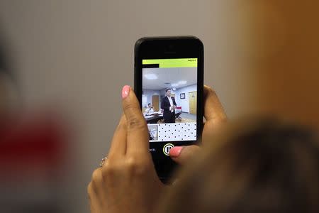 People photograph Art Alas, Republican candidate in the California 32rd Congressional District against Democrat Grace Napolitano, at a meeting of so-called "Liberty Kids" libertarian Republican activists in Burbank, California, July 27, 2014. REUTERS/David McNew