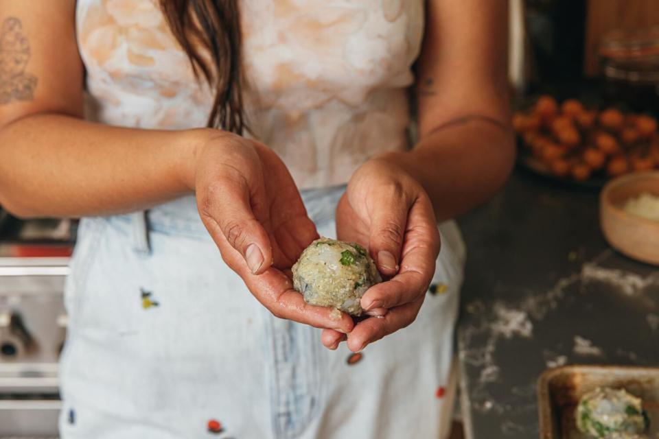 Paola Briseño-González preparing Caldo de Albóndigas de Camarón.