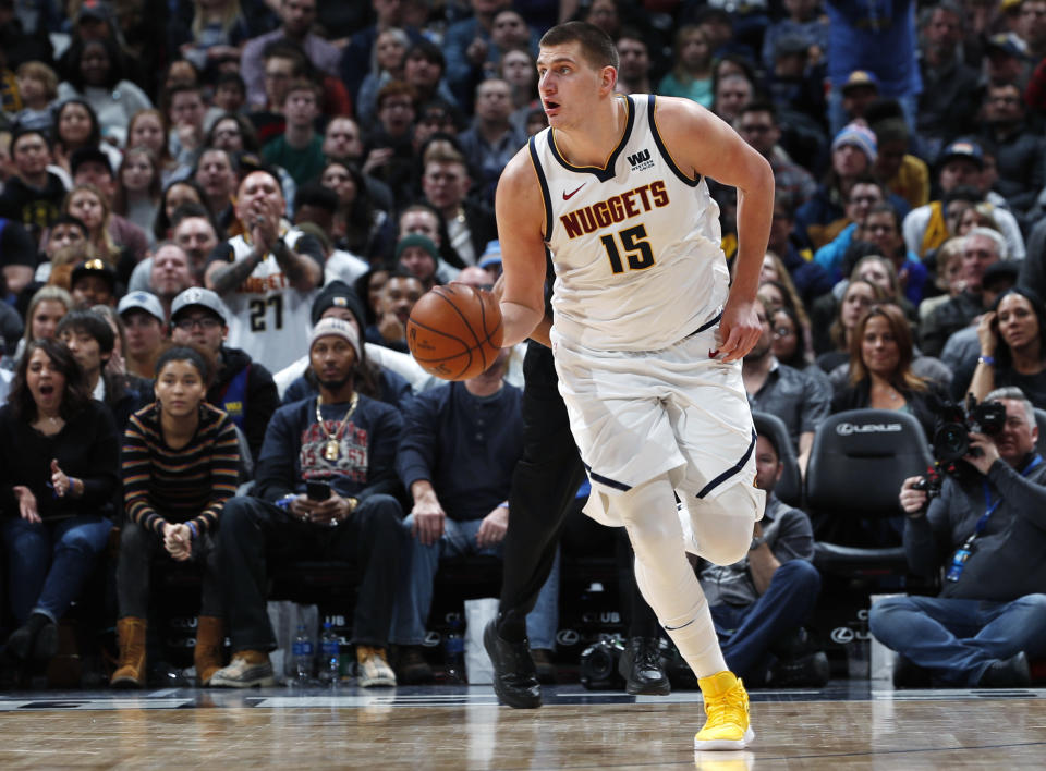 FILE - In this Tuesday, Jan. 1, 2019, file photo, Denver Nuggets center Nikola Jokic picks up a loose ball and heads down the court in the second half of an NBA basketball game against the New York Knicks in Denver. Jokic, a 7-footer from Serbia, is leading the Nuggets to new heights so far this season with his style of play in the pivot. (AP Photo/David Zalubowski, File)