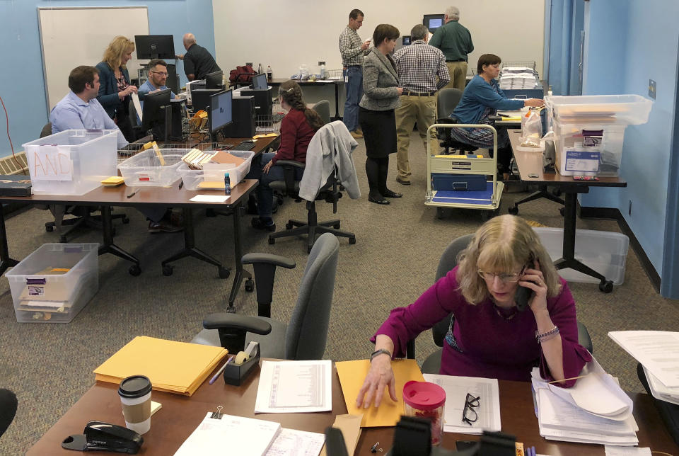 Maine election officials, including Democratic Deputy Secretary of State Julie Flynn, right, began counting ballots on Friday, Nov. 9, 2018, in Augusta for the Second Congressional District's House election. The election is the first congressional race in American history to be decided by the ranked-choice voting method that allows second choices. (AP Photo/Marina Villeneuve)