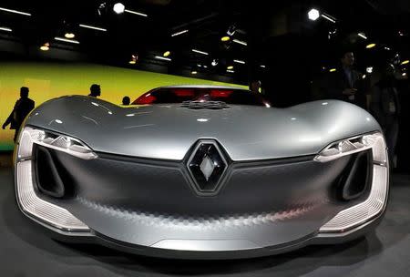 FILE PHOTO: Visitors walk past the newly launched Renault Trezor, a two-seater electric concept car, at the India Auto Show 2018 in Greater Noida, India February 7, 2018. REUTERS/Saumya Khandelwal/File Photo