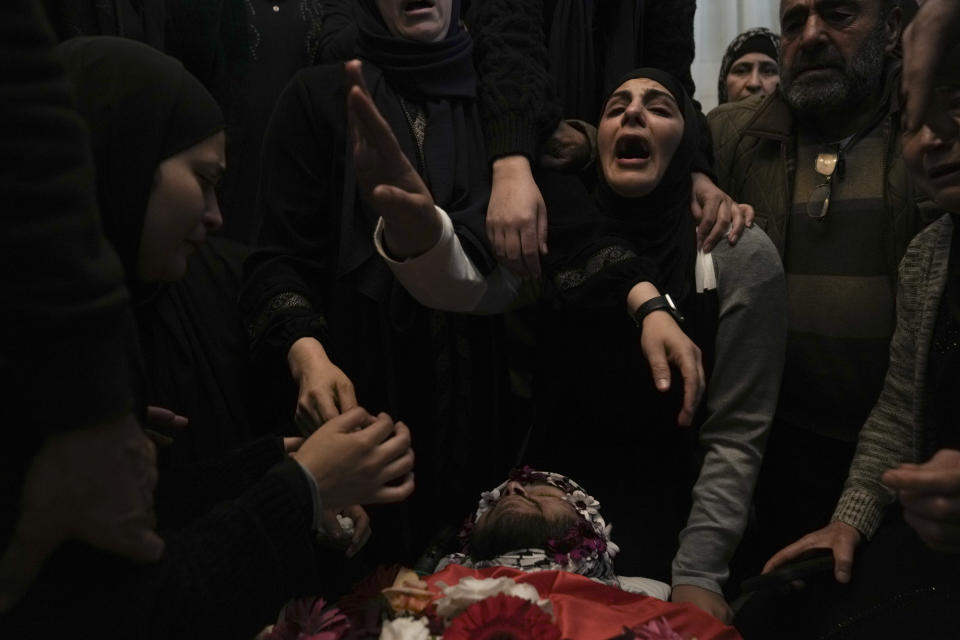 CORRECTS DETAILS OF DEATH Relatives mourn 17-year-old American Tawfiq Ajaq at his funeral in his family’s Palestinian home village in Al-Mazra'a ash-Sharqiya, West Bank, Saturday, Jan. 20, 2024. Ajaq was killed Friday by Israeli fire and police say they have launched an investigation. (AP Photo/Nasser Nasser)