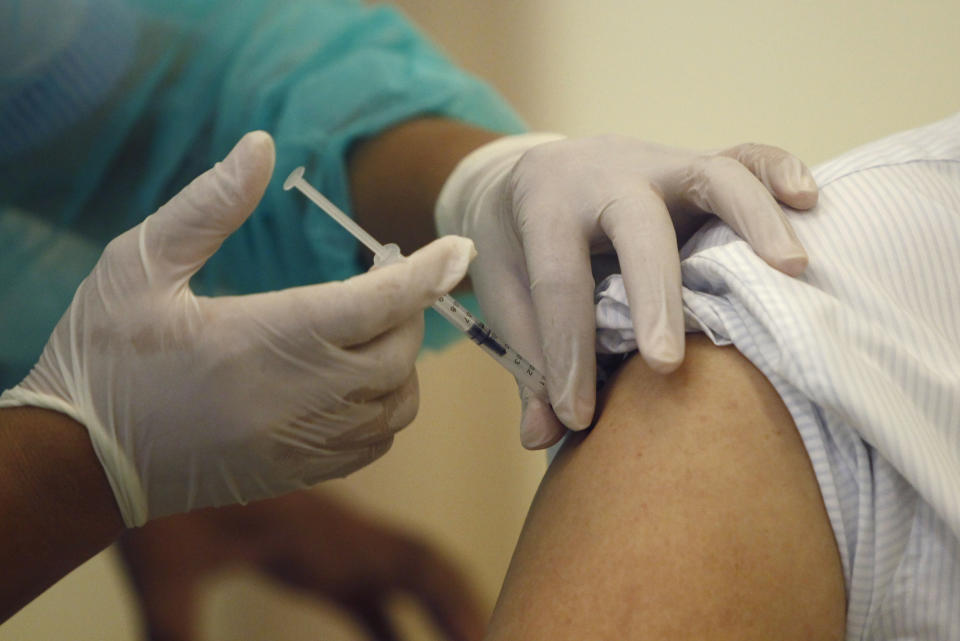 A Cambodian nurse gives a shot of the COVID-19 vaccine at Calmette hospital in Phnom Penh, Cambodia, Wednesday, Feb. 10, 2021. Cambodia began its inoculation campaign against the COVID-19 virus with vaccines donated from China, the country’s closest ally. (AP Photo/Heng Sinith)