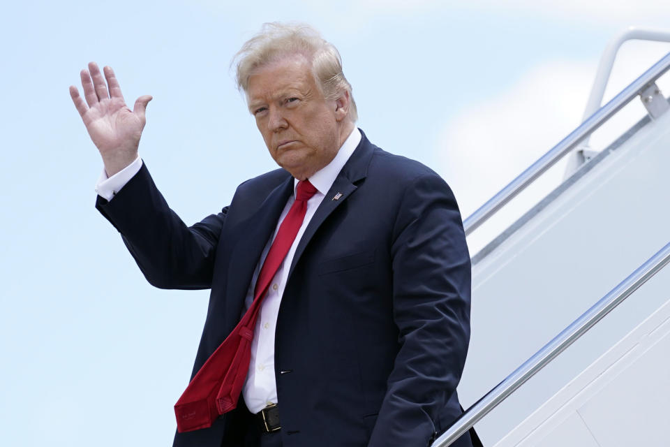 President Donald Trump waves as he arrives on Air Force One at Austin Straubel International Airport in Green Bay, Wis., Thursday, June 25, 2020. (AP Photo/Evan Vucci)