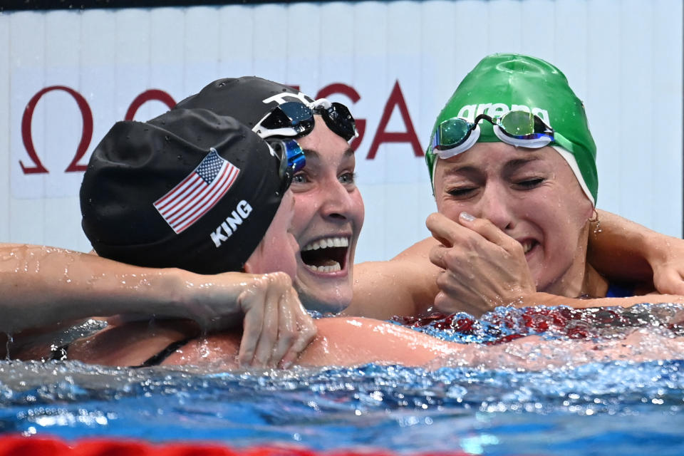 South Africa's Tatjana Schoenmaker (R) reacts with third placed USA's Annie Lazor (C) and second placed USA's Lilly King after winning the final of the women's 200m breaststroke swimming event to set a new World Record during the Tokyo 2020 Olympic Games at the Tokyo Aquatics Centre in Tokyo on July 30, 2021. (Photo by Jonathan NACKSTRAND / AFP) (Photo by JONATHAN NACKSTRAND/AFP via Getty Images)