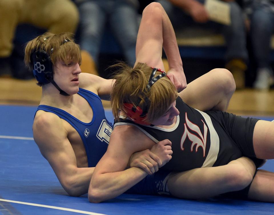 Kade Kluce of Dundee tries to turn Steve Skinner of Lowell before winning by fall in the 119-pound match Friday, January 29, 2022.