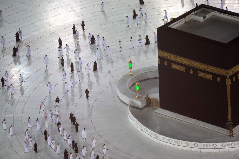 The first group of Muslims, allowed in the mosque compound by appointment, practice social distancing, as they perform Umrah in the Grand Mosque, after Saudi authorities ease coronavirus disease (COVID-19) restrictions, in the holy city of Mecca