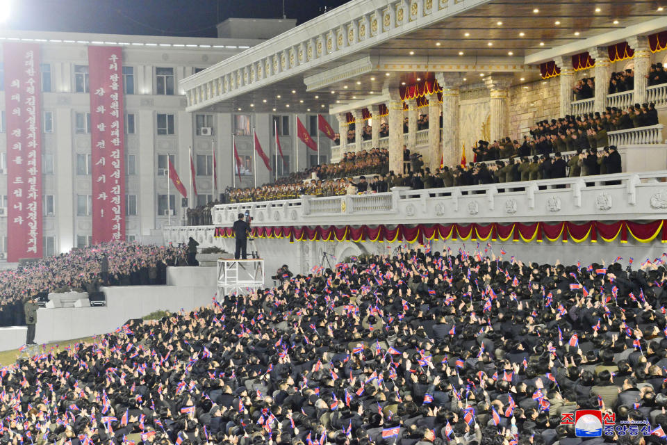 In this photo provided by the North Korean government, people wave the national flags as North Korean leader Kim Jong Un, center top, attends a military parade, at Kim Il Sung Square in Pyongyang, North Korea Thursday, Jan. 14, 2021. North Korea rolled out developmental ballistic missiles designed to be launched from submarines and other military hardware in a parade that punctuated leader Kim Jong Un’s defiant calls to expand his nuclear weapons program. Independent journalists were not given access to cover the event depicted in this image distributed by the North Korean government. The content of this image is as provided and cannot be independently verified. Korean language watermark on image as provided by source reads: "KCNA" which is the abbreviation for Korean Central News Agency. (Korean Central News Agency/Korea News Service via AP)