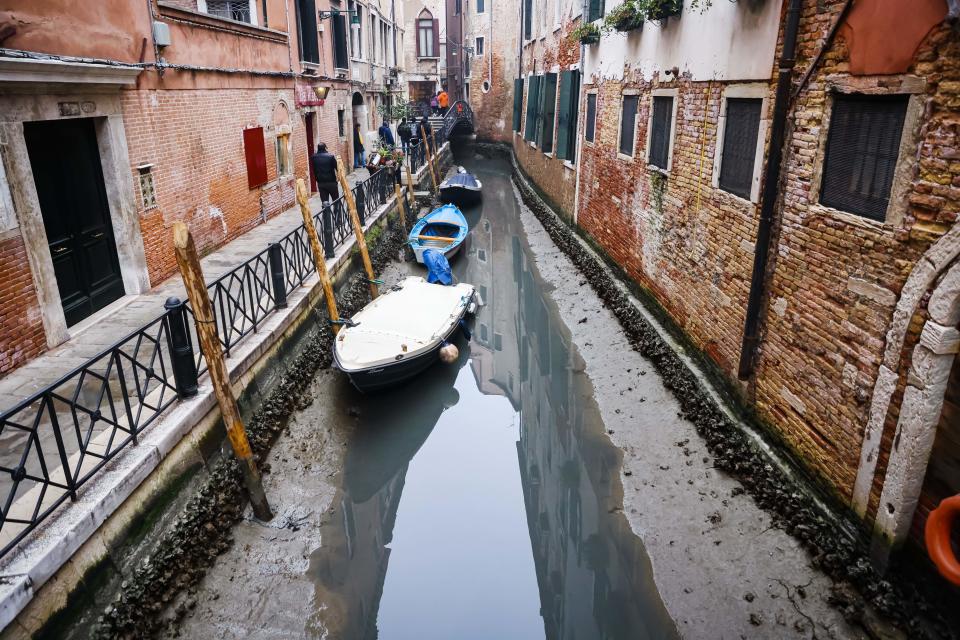 A dry canal is seen at low tide in Venice, Italy, February 16, 2023. / Credit: Alessandro Bremec/NurPhoto/Getty