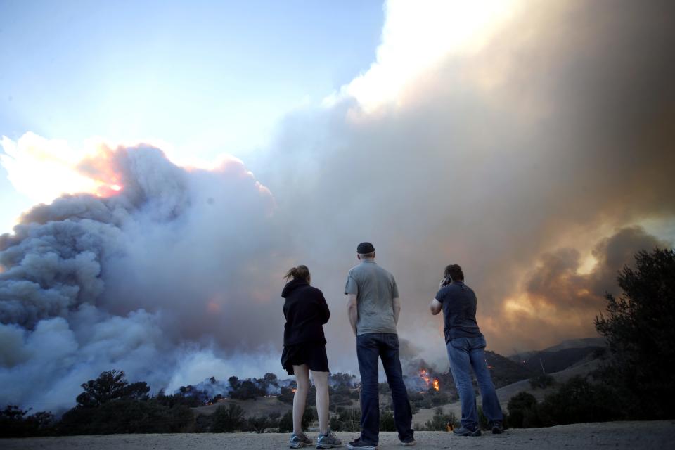 <p>People watch smoke rise from the Woolsey Fire in Malibu, California on Nov. 9, 2018.<br>The Woolsey Fire has led to the evacuation order for 75,000 homes. Fires across California fueled by very dry conditions and warm strong Santa Ana winds have destroyed structures and caused fatalities.<br>(Photo from Mike Nelson, EPA) </p>