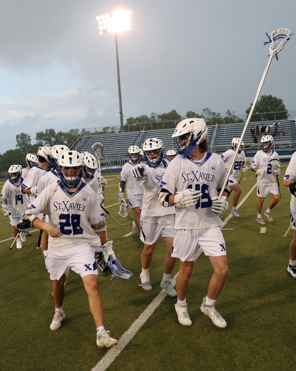 Saint Xavier players celebrate their victory over Springboro in the Division I regional championship game at Saint Xavier May 27, 2022.