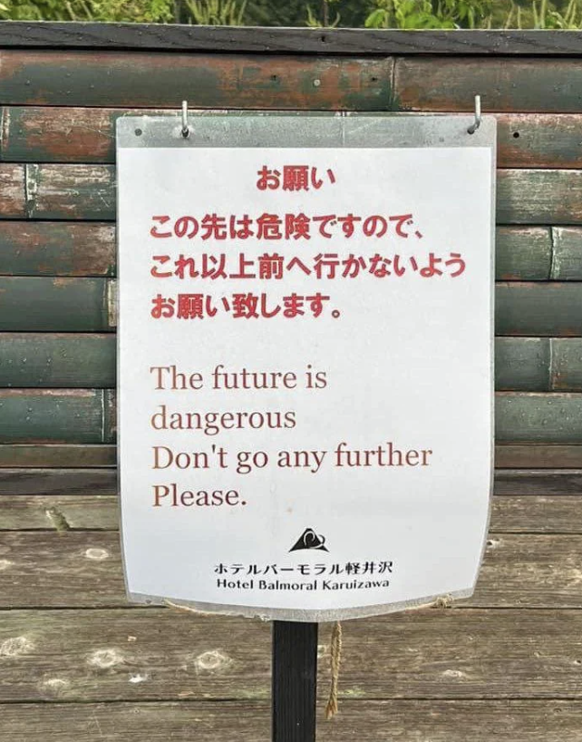Sign warning "The future is Dangerous. Don't go any further" in English and Japanese, possibly humorous