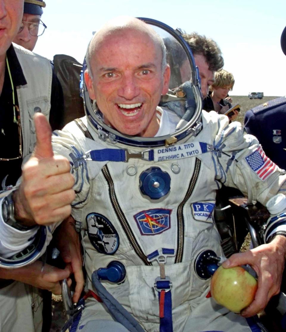 FILE - In this Sunday, May 6, 2001 file photo, U.S. multimillionaire Dennis Tito gives a thumbs up shortly after his landing in the Central Asian steppes, 80 kilometers (50 miles) northeast of Arkalyk, Kazakstan. The Russian Soyuz capsule carrying the world's first paying space tourist landed successfully, capping off Tito's multimillion dollar cosmos adventure. (AP Photo/Mikhail Metzel)