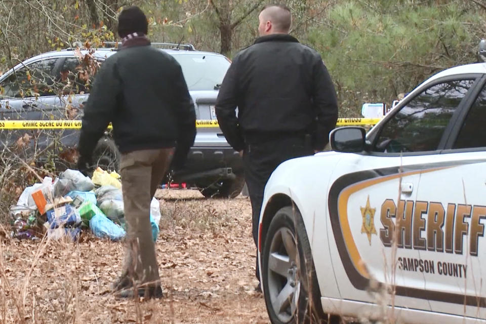 Investigators at the homeless encampment. (WRAL)