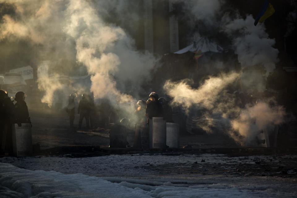 Riot police officers take positions blocking a street near Kiev's Independence Square, the epicenter of the country's current unrest, Ukraine, Friday, Jan. 31, 2014. Ukraine's embattled president Viktor Yanukovych is taking sick leave as the country's political crisis continues without signs of resolution. (AP Photo/Emilio Morenatti)