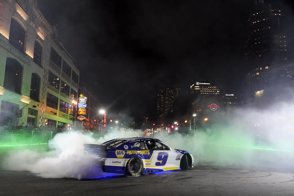 Chase Elliott does a burnout during the Burnouts on Broadway competition as part of NASCAR Champion's Week, Wednesday, Dec. 1, 2021, in Nashville, Tenn. (AP Photo/Mark Humphrey)