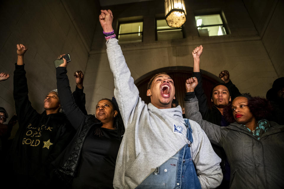 Christian Carter, of Pittsburgh's East Liberty neighborhood, left, leads a chant with other supporters of Antwon Rose II after they learned a not guilty verdict in the homicide trial of former East Pittsburgh police Officer Michael Rosfeld, Friday, March 22, 2019, at the Allegheny County Courthouse in downtown Pittsburgh, Pa. A jury acquitted Rosfeld, a former police officer Friday in the fatal shooting of Antwon Rose II, an unarmed teenager as he was fleeing a high-stakes traffic stop outside Pittsburgh, a confrontation that was captured on video and led to weeks of unrest. (Michael M. Santiago/Pittsburgh Post-Gazette via AP)