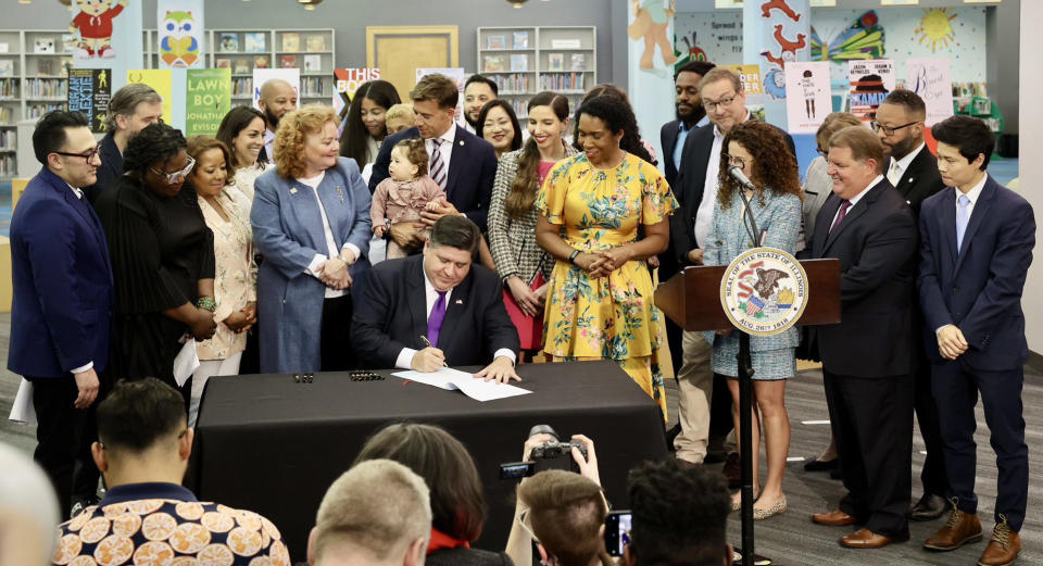 Gov. J.B. Pritzker signs a bill, Monday, June 12, 2023, at Harold Washington Library's Thomas Hughes Children's Library in downtown Chicago. (Gov. J.B. Pritzker via Twitter)