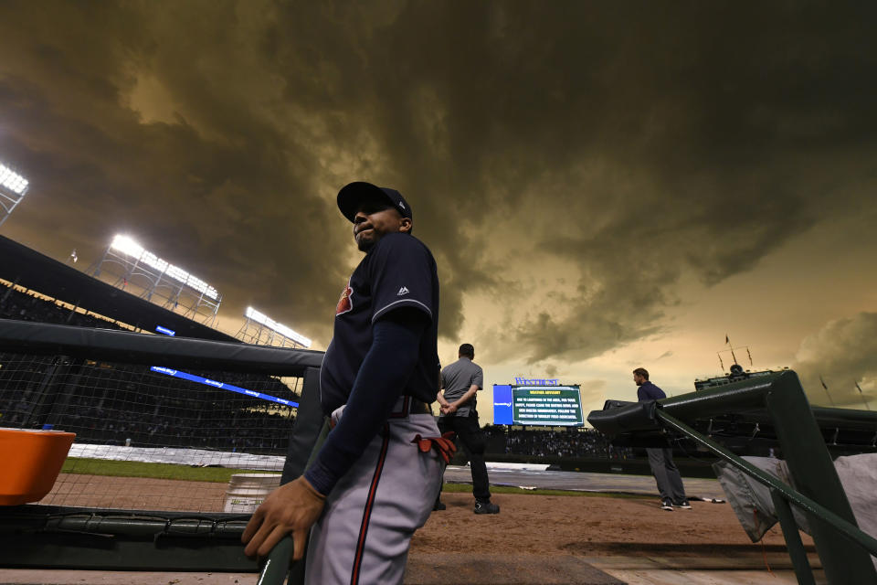 Atlanta Braves left fielder Johan Camargo looks on from the dugout during a lightning delay in the fourth inning of the team's baseball game against the Chicago Cubs on Wednesday, June 26, 2019, in Chicago. (AP Photo/Paul Beaty)