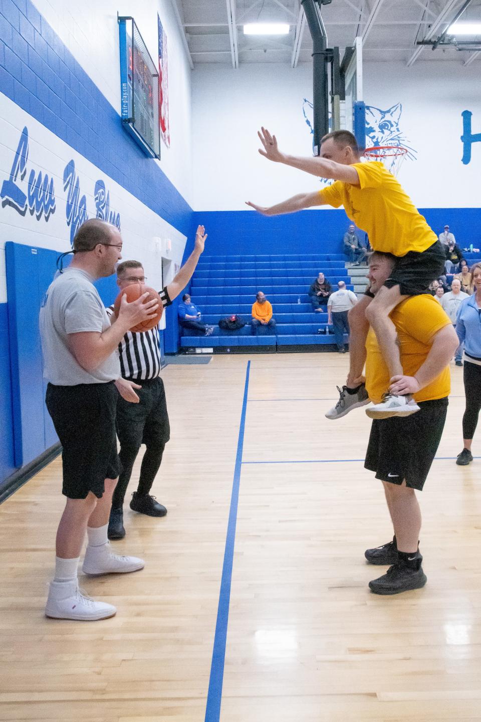 Eagles player Shawn Lemley takes on a double stack of sheriff's deputies during the annual fundraising game.