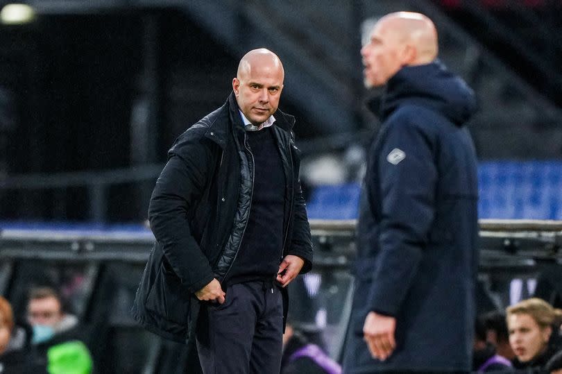 Arne Slot looks on from the touchline, with Erik ten Hag standing in the foreground