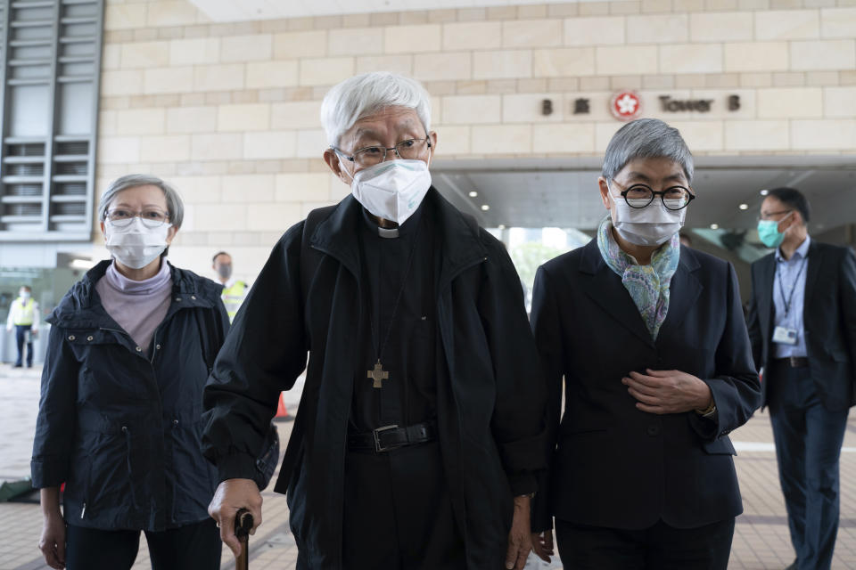 From left, former lawmaker Cyd Ho, Cardinal Joseph Zen and barrister Margaret Ng walk out of the West Kowloon Magistrates's Courts after the verdict session in Hong Kong, Friday Nov. 25, 2022. Zen and five others in Hong Kong were fined after being found guilty Friday of failing to register a now-defunct fund that aimed to help people arrested in the widespread protests three years ago. (AP Photo/Anthony Kwan)