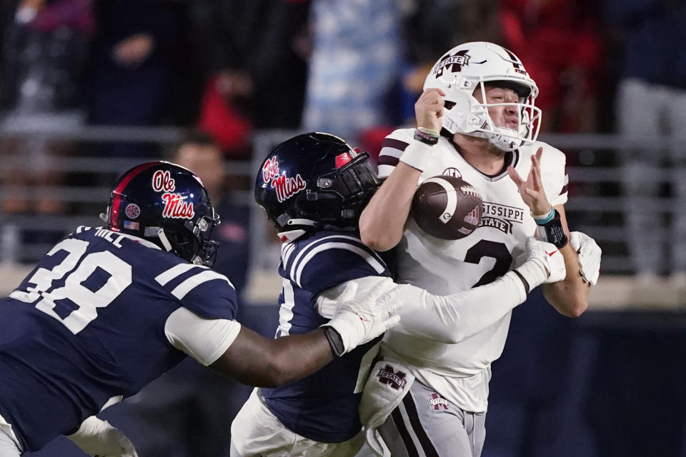 Mississippi linebacker Khari Coleman (23) forces Mississippi State quarterback Will Rogers (2) to fumble during the first half of an NCAA college football game in Oxford, Miss., Thursday, Nov. 24, 2022. (AP Photo/Rogelio V. Solis)