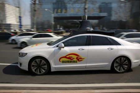 A Baidu's Apollo autonomous car is seen during a public road test for self-driving vehicles in Beijing, China March 22, 2018. REUTERS/Stringer