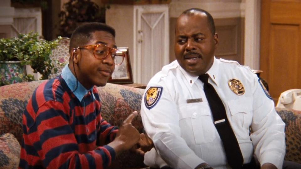 Steve Urkel and Carl sitting on the couch in Family Matters
